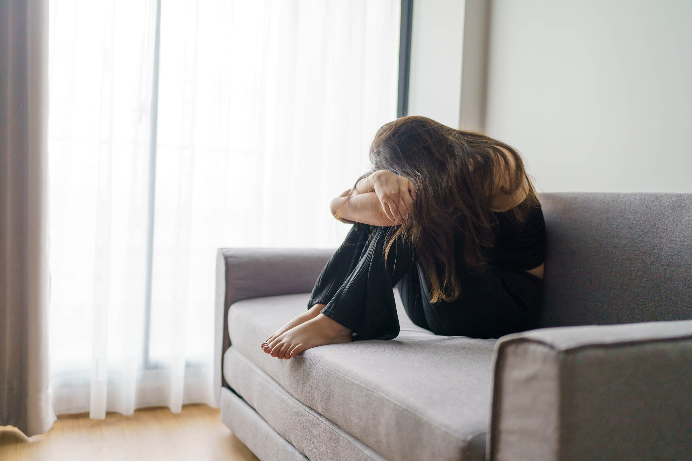 Sad Woman Thinking About Problems Sitting On A Sofa Upset Girl F